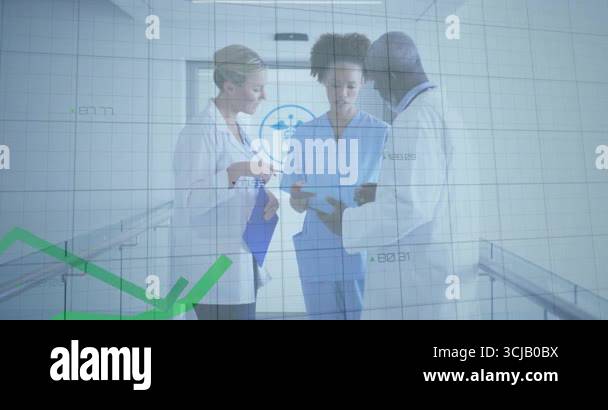 Medical team tapping tablet and pointing clipboard in corridor while ...