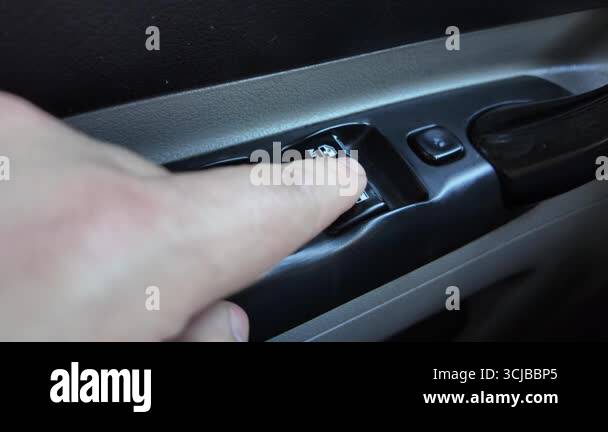 analog window lift buttons. man opens window in car. old buttons in car ...