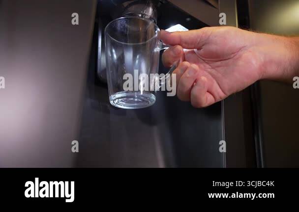 Falling Mug Empty The video shows a person holding an empty glass mug under a dispenser ...