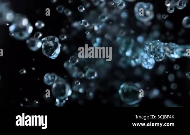 Super Slow Motion Shot of Flying Water Drops on Black Background at ...