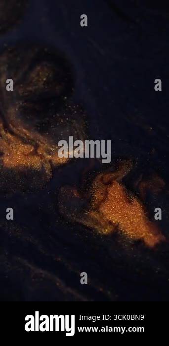 Vertical video. Glitter explosion. Shimmering spill. Golden powder ...