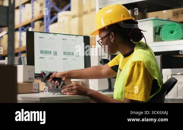 Black female with hi vis vest registering awb tracking info with ...