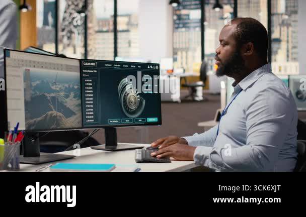 Technician using CAD software to optimize wind turbine blade ...