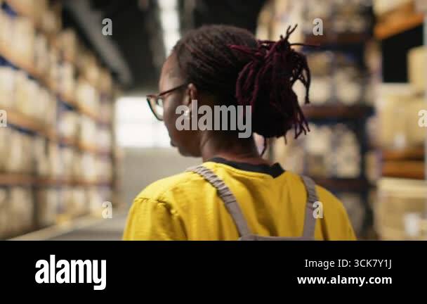 African american worker processing merchandise for business logistics ...