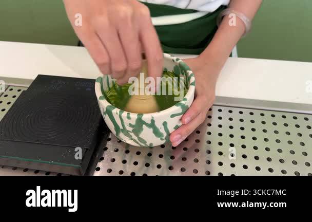 Whisking matcha tea traditional Japanese style bowl for brewing fresh ...