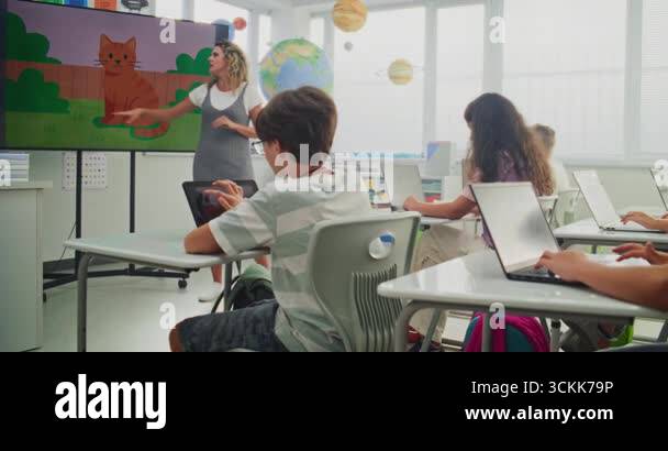 Elementary School Children Drawing Pictures on Laptops During Digital ...