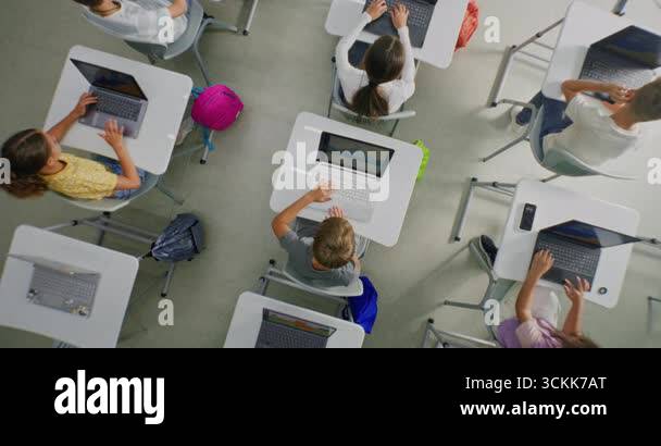 Elementary School Children Using Laptops, Creating Drawings During ...