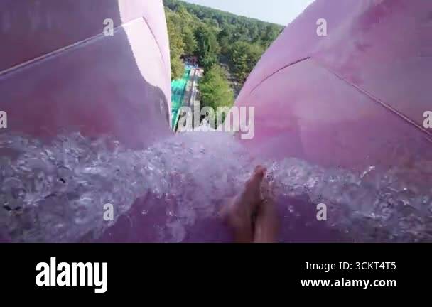 Vertical Fall Water Rider POV of an extreme free fall ride down a tall vertical waterslide. High ...