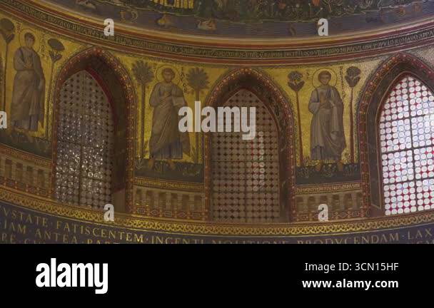 Rome, ITALY, JULY 30th, 2025 - Detailed golden mosaics of saints and ...