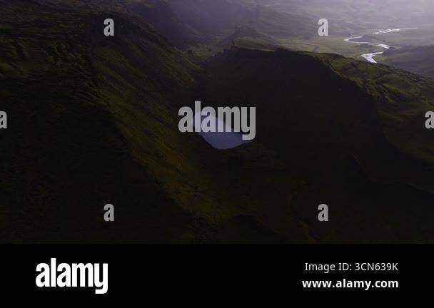 Sweeping Aerial View Of Maelifell Volcano Green Hills A Serene Lake sweeping-aerial-view-of-maelifell-volcano-green-hills-a-serene-lake