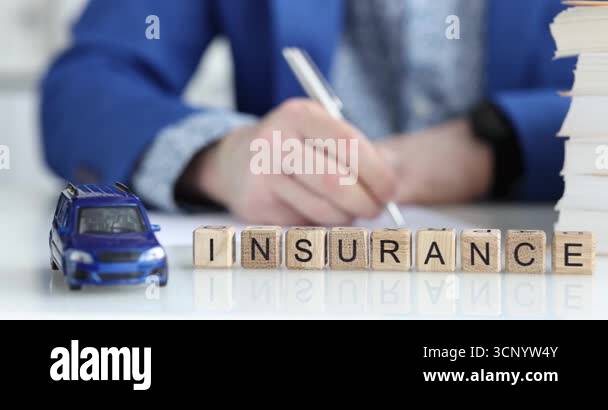Wooden blocks spell word Insurance near blue toy car and busy person at ...