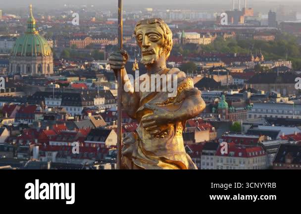 Aerial drone view of the golden statue atop a sphere on the Church of ...