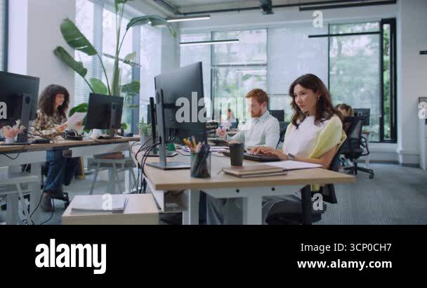 Camera view of busy diverse managers working in large modern office ...
