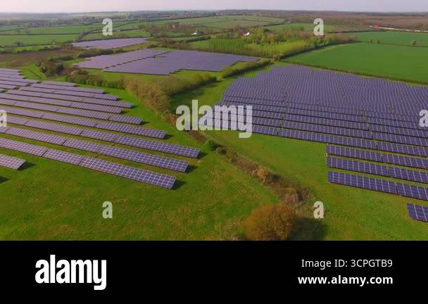 Aerial view of large solar panel arrays on a solar farm on adapted ...