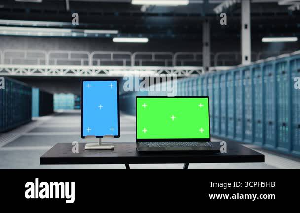 Isolated screen tablet and laptop in high tech data center facility ...