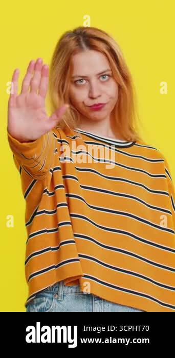 Stop, enough. Young adult woman say no hold palm folded crossed hands ...