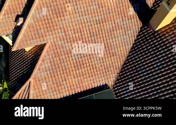 Top down view of tiled roof on a luxury home, roof inspection concept ...
