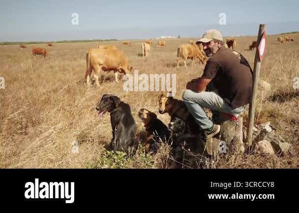 Sagres, Algarve, Portugal 2025.07.01 A smiling farmer sits on a rock ...
