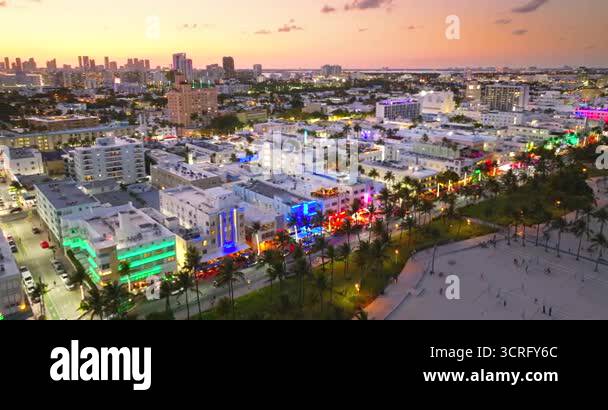 Art Deco buildings lit up along Ocean Drive in Miami Beach. Lively ...