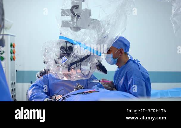 Neurosurgeon using surgical microscope during brain operation. Doctor ...