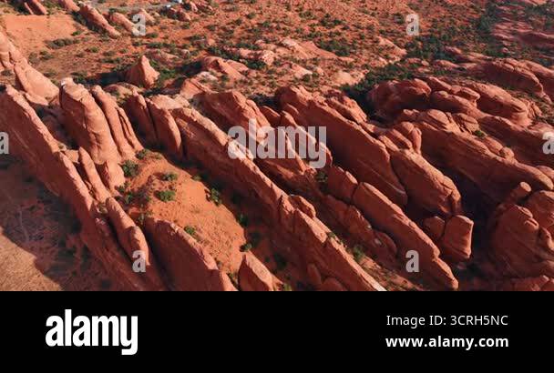 Thin ridges of red rocks in the dry desert. Drone footage over the ...