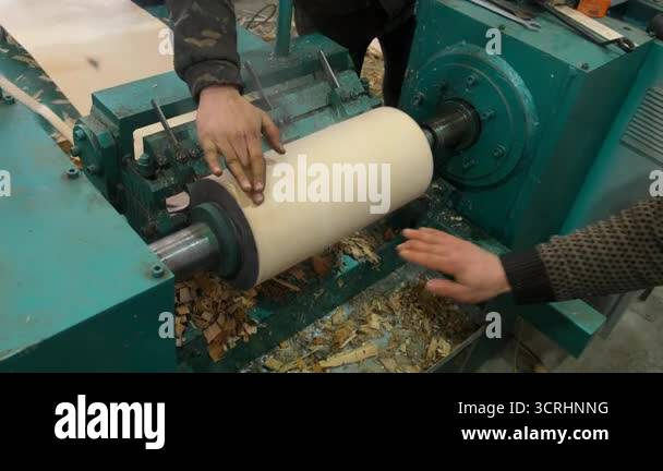 Timber Manipulation Woodworker operating wood cutting lathe machine on woodworking factory ...