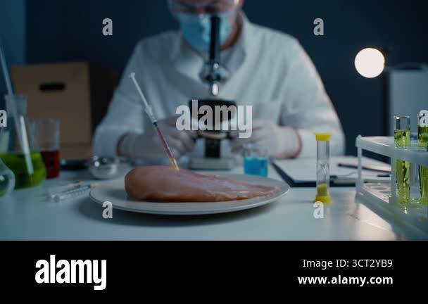 Young male nutrition expert testing food products in lab. Genetic ...