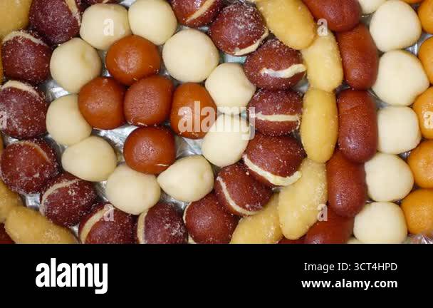 Delight in a colorful array of Indian sweets arranged perfectly on a ...