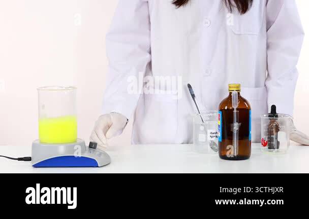 Scientist demonstrates iodine clock reaction experiment with laboratory ...