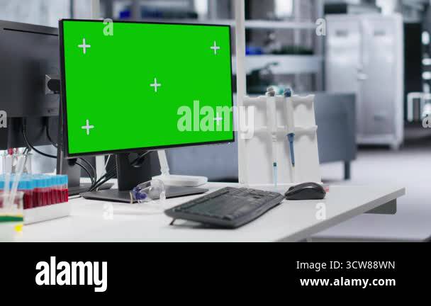 Instruments Greescreen Green screen desktop pc on a desk in empty laboratory setting, testing ...