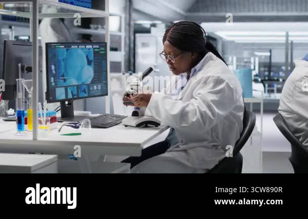 African american woman analyzing molecular samples in a bio lab, using ...
