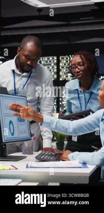 Vertical Video Black team of male consultants reviewing data analytics ...