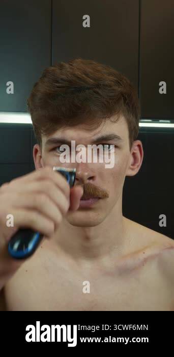 Male shaves head with electric razor at home. Close up of man's head ...