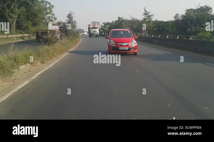 Fast moving Car driving approaching towards the camera in a city street ...