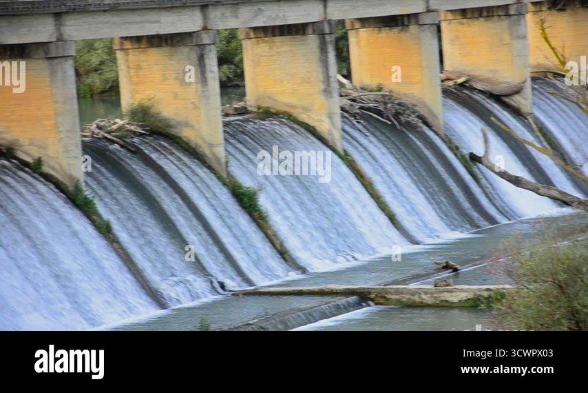 Spring Fed Dams Spring flood water flowing on hydroelectric power station dam, PANNING ...