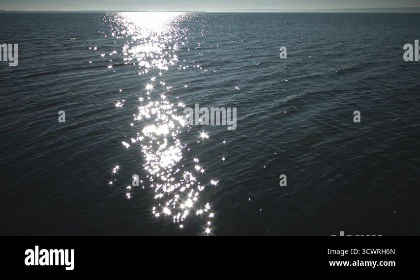 Glare of the sun on the water. Clear sea water, sun sparks on the water ...