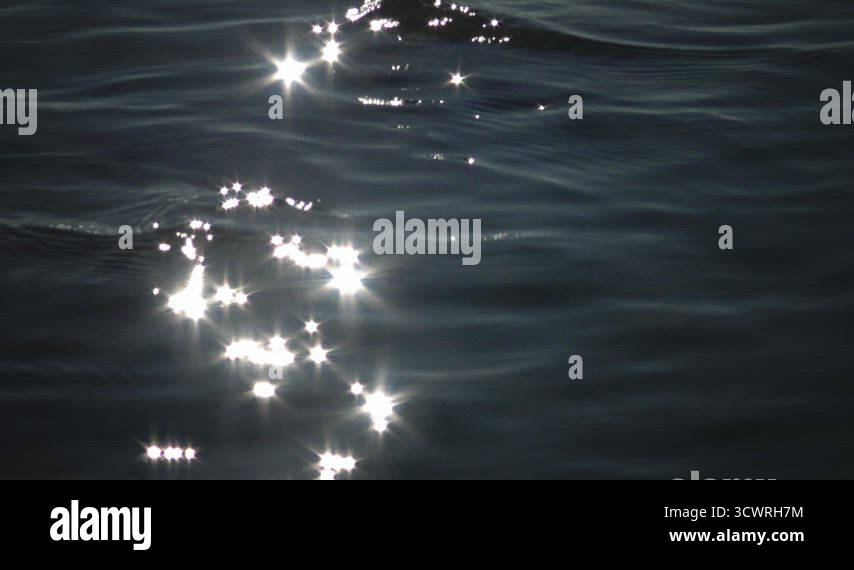 Glare of the sun on the water. Clear sea water, sun sparks on the water ...