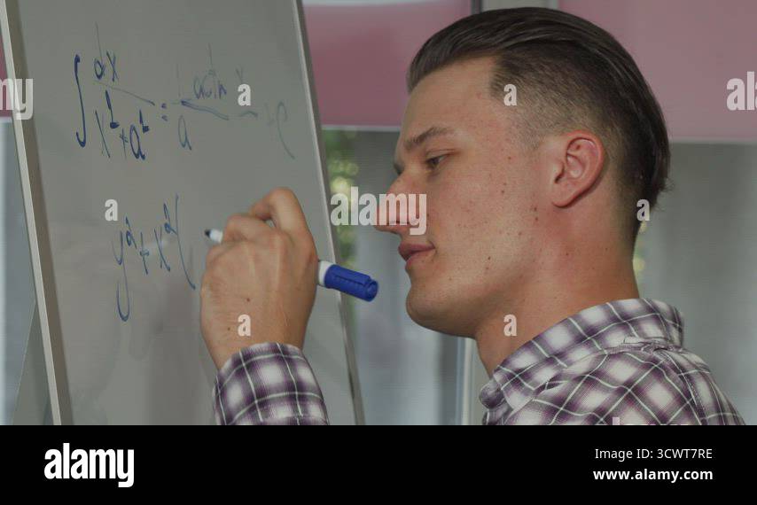 Handsome young man solving math problem on whiteboard Stock Video ...