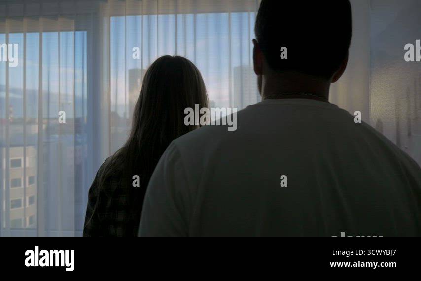 Couple Cuddling by the Window Stock Video Footage - Alamy