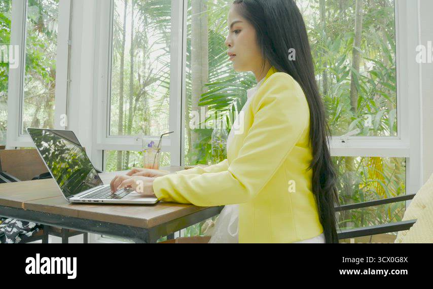 4K footage. business woman typing on a laptop keyboard at coffee shop ...