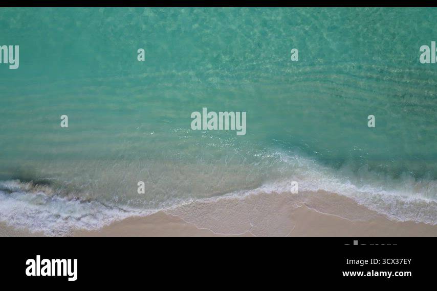 Daytime above abstract shot of a white sandy paradise beach and blue ...