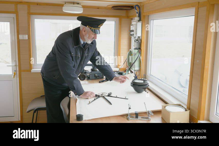 Captain of the ship is plotting the navigation route on the map in the ...