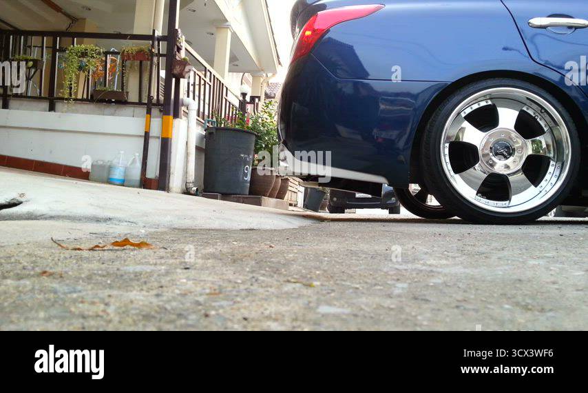 Sloping Rear Car Driving a lowered car on a sloping car park Stock Video Footage - Alamy
