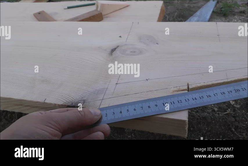 Measuring dimensions with a ruler during construction from wood Stock ...