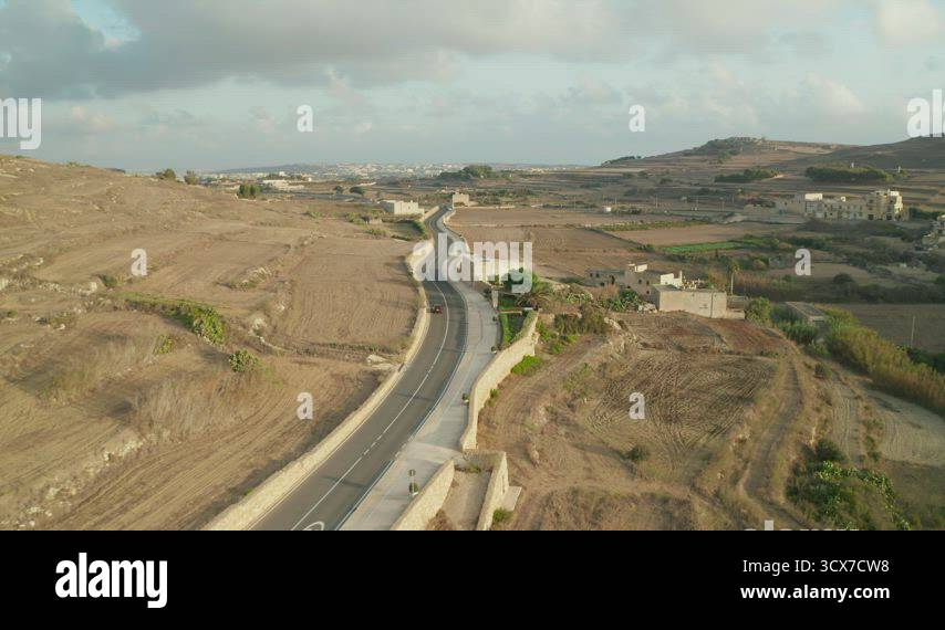 Single Red Car driving on Empty road through Rural Mediterranean ...