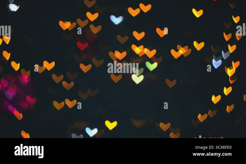 Blurred red orange warm shape hearts blink on tree beautiful night ...