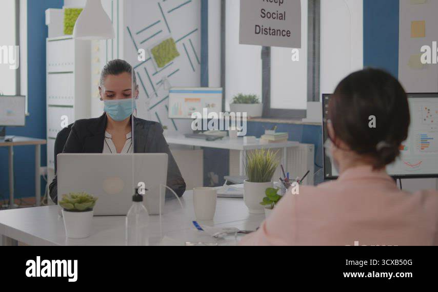 Business team with medical face masks working together in startup ...