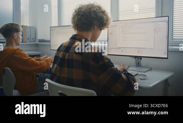 Two Young Men Writing Code in Classroom. University Students Sit at ...