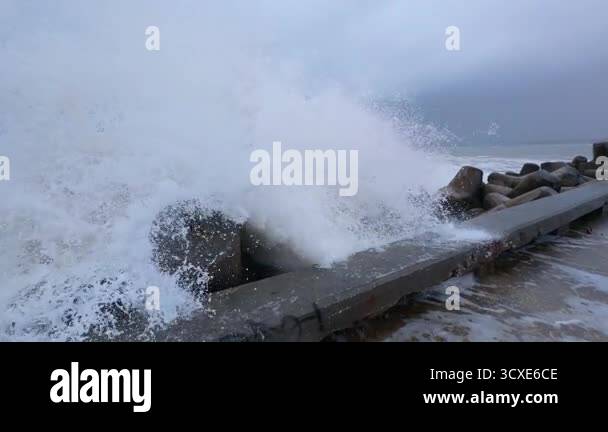 Powerful storm waves crashing against a pier, first-person view of ...
