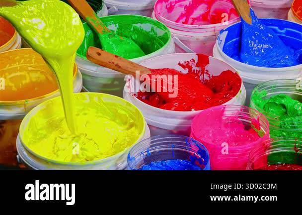Color Dripping Bucket scoop green color of Plastisol ink. Buckets of Colorful Paint. Close up ...